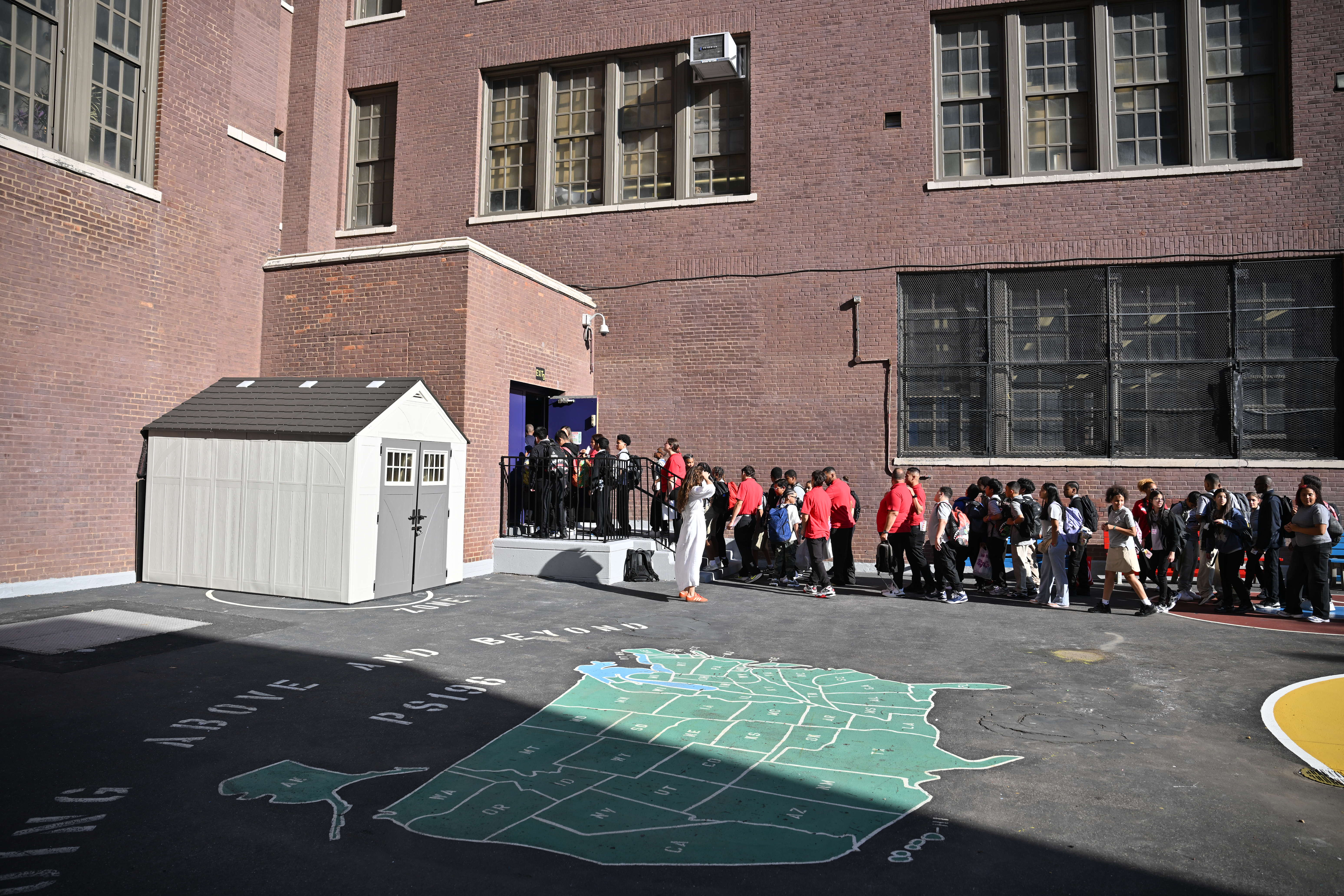 Students line up to go back to school.