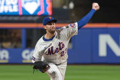 David Peterson Mets: Man in white uniform and blue hat throws baseball