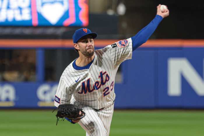 David Peterson Mets: Man in white uniform and blue hat throws baseball