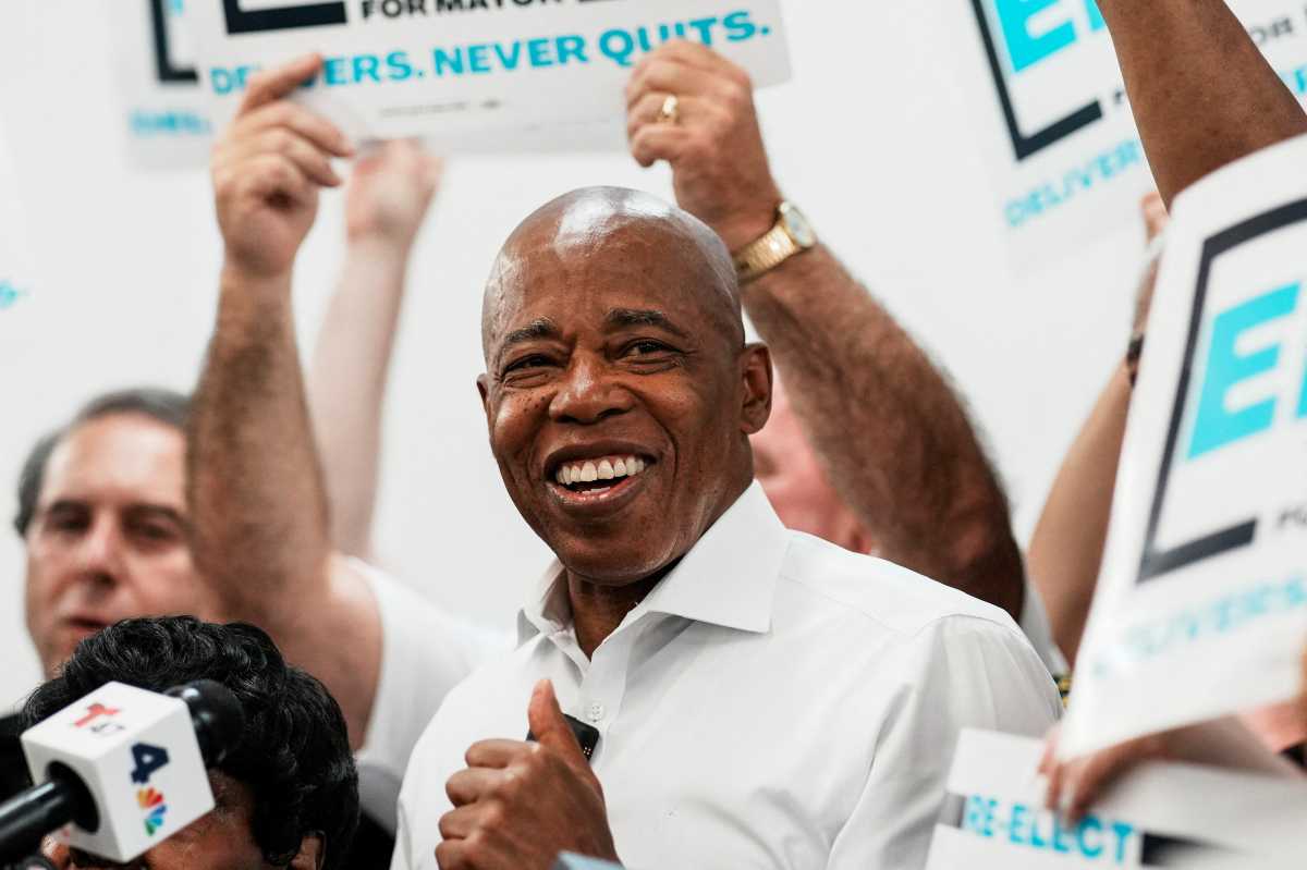 Mayor Eric Adams smiling with thumbs up amid mayoral campaign