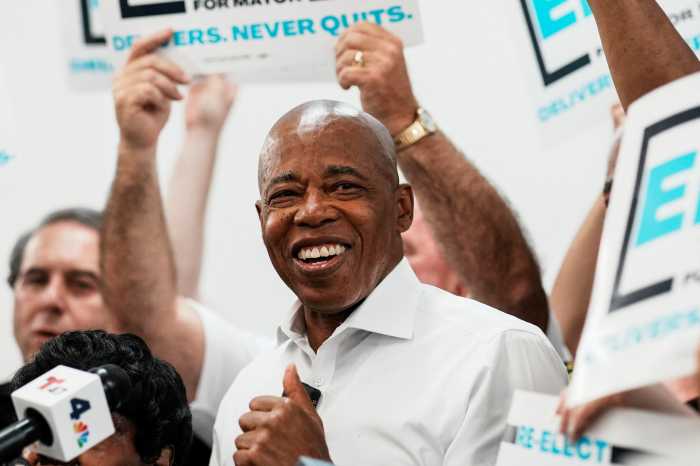 Mayor Eric Adams smiling with thumbs up amid mayoral campaign