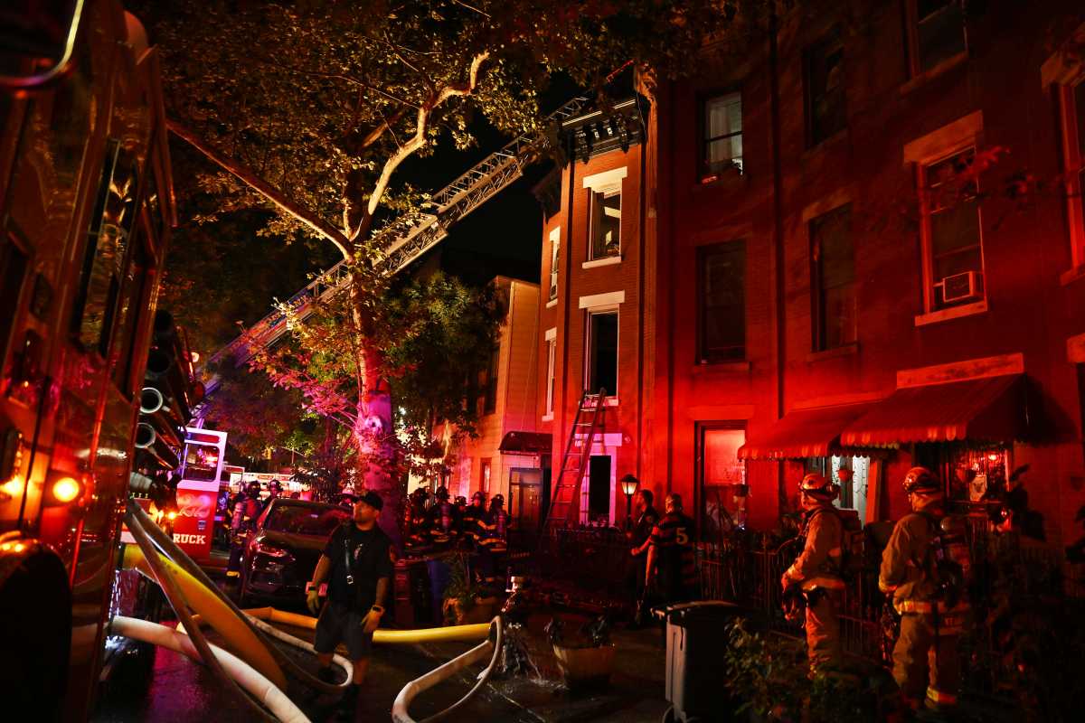 firefighters in Brooklyn at night, battling a fire