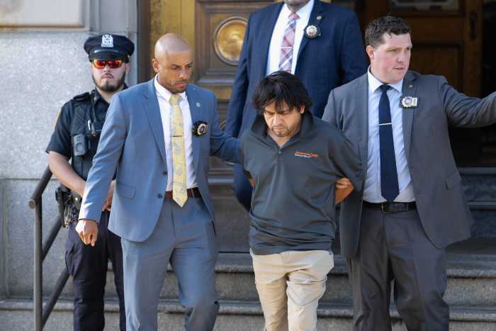 suspect in Bronx murder escorted by police detectives in handcuffs