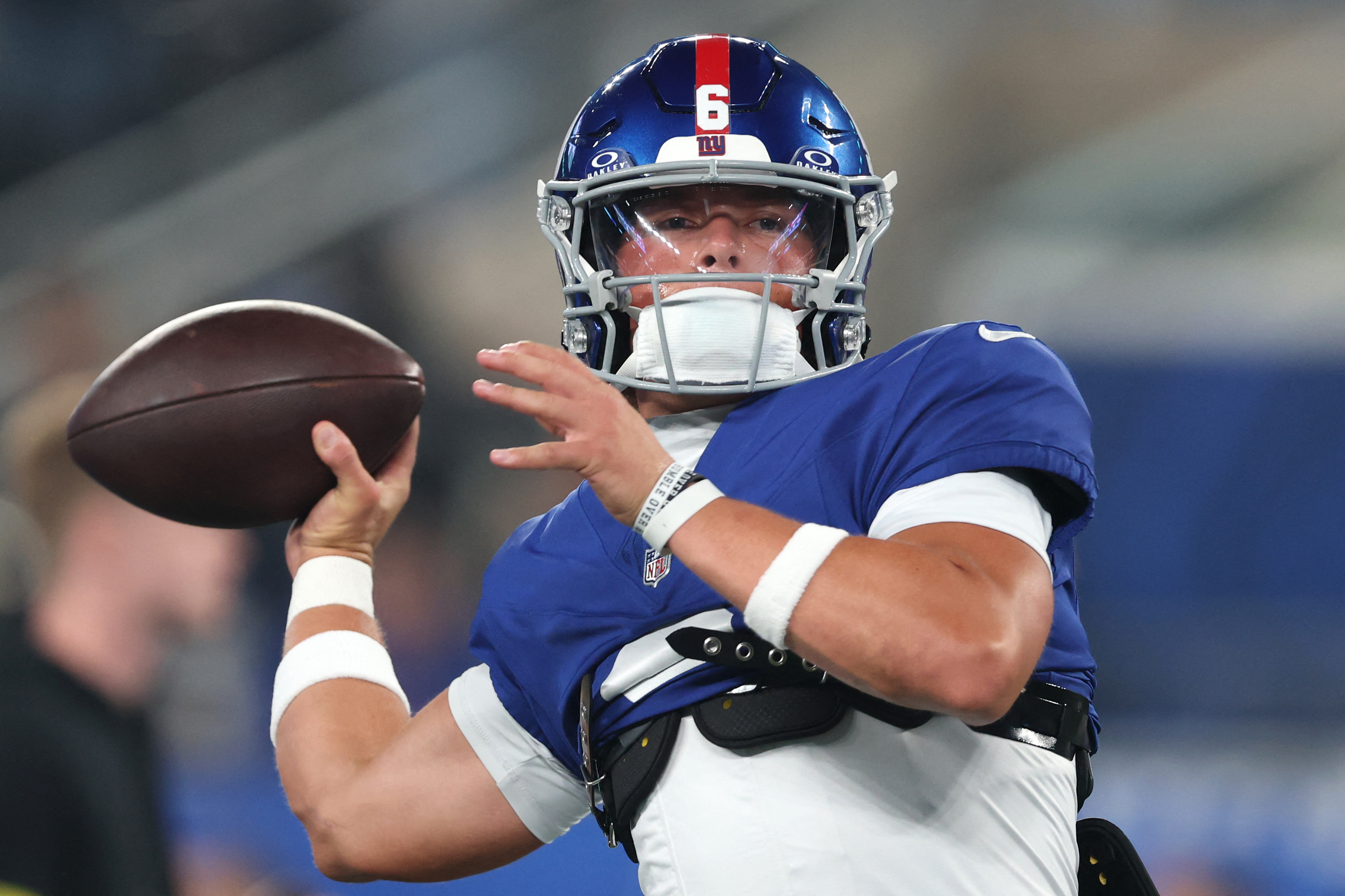 Jaxson Dart Giants Chiefs warmup: Football player in blue uniform warms up pregame