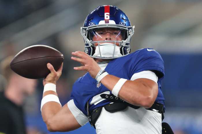 Jaxson Dart Giants Chiefs warmup: Football player in blue uniform warms up pregame