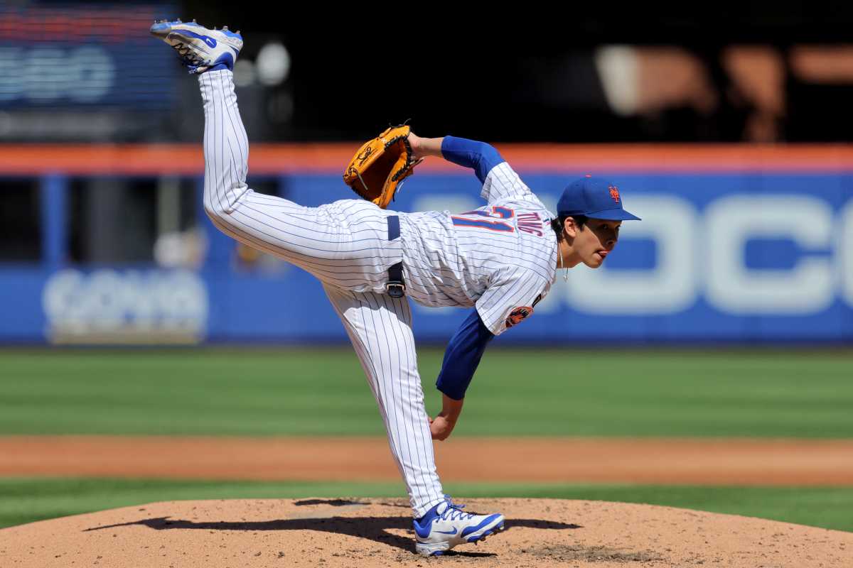 Jonah Tong Mets padres: Man in white baseball uniform follows through on delivery