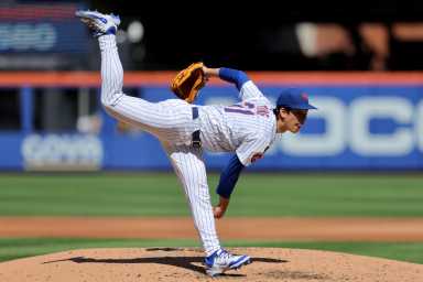 Jonah Tong Mets padres: Man in white baseball uniform follows through on delivery