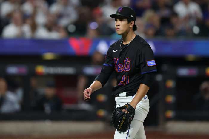 Jonah Tong Mets Marlins: Man in black uniform walks off baseball field