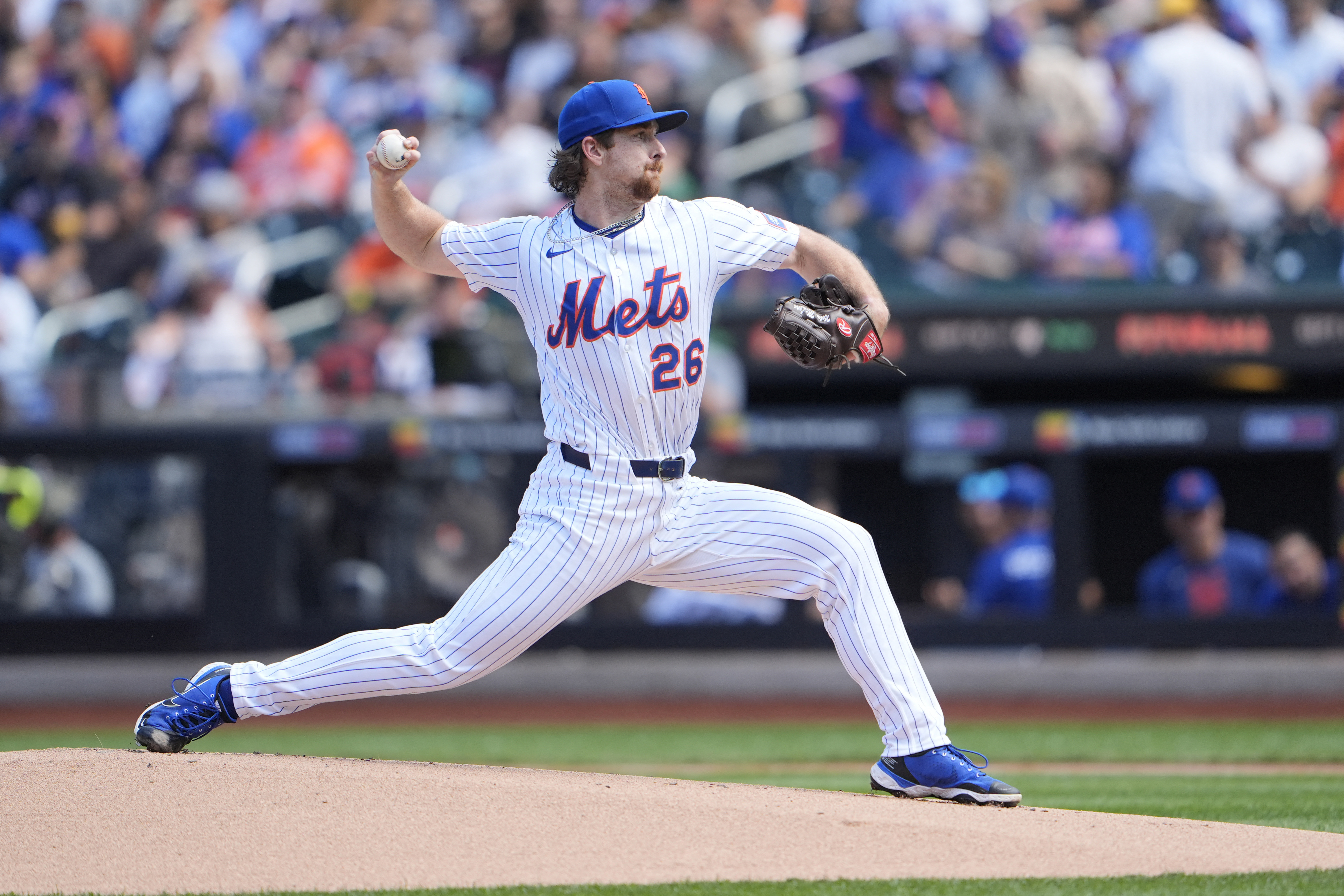 Nolan McLean Mets Rangers: Man in white baseball uniform delivers pitch toward home plate.