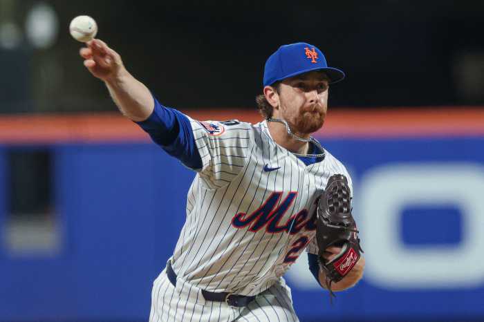 Nolan McLean Mets Phillies: Man in white uniform and blue hat throws baseball