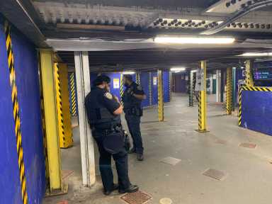 police officers in uniform inside a subway station