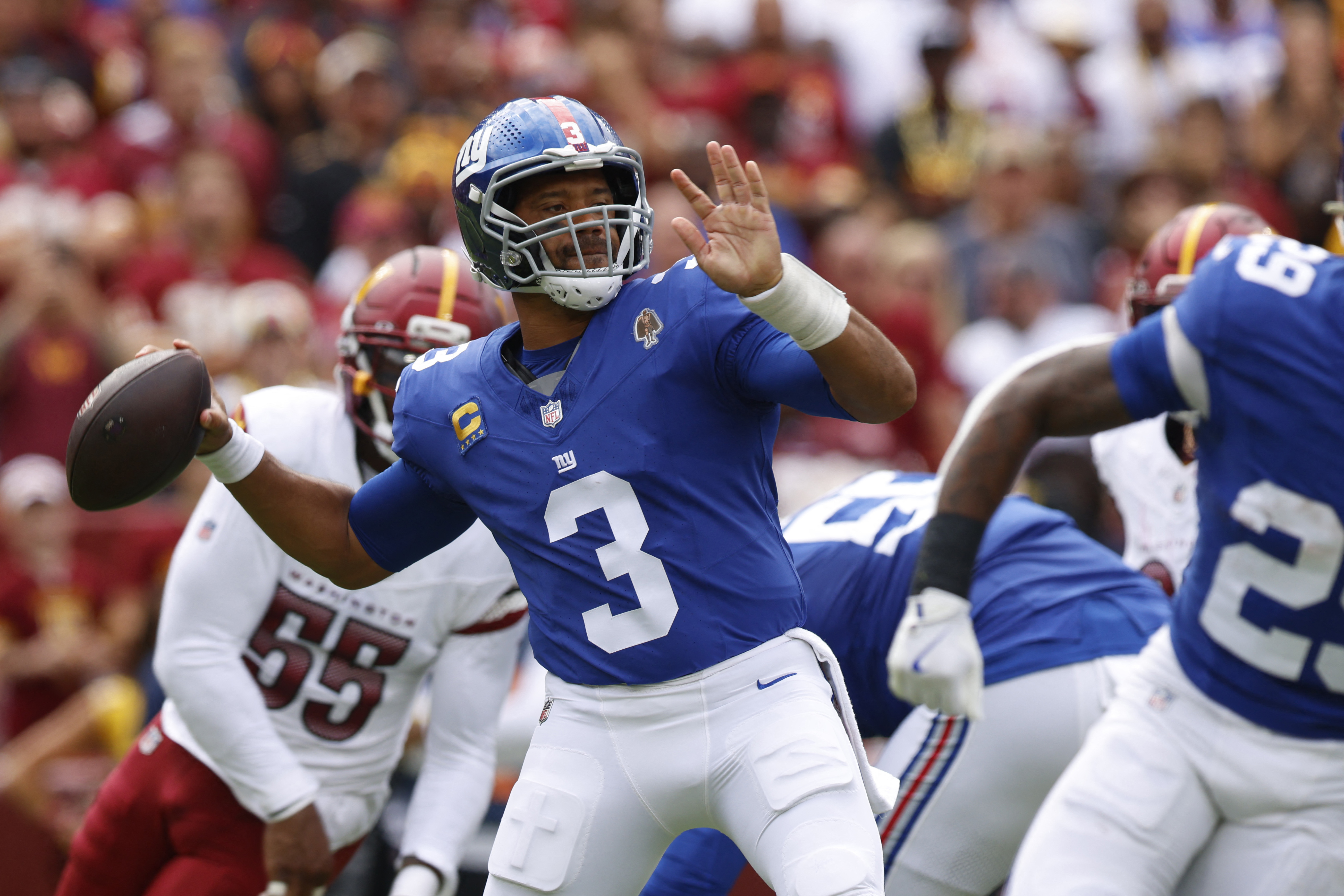 Giants vs. Cowboys Week 2 preview: Is the Jaxson Dart watch on? 2 Russell Wilson Giants: Man in blue football uniform and helmet throws ball