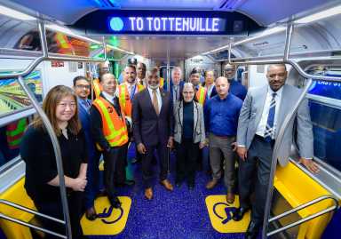 group of people on board a Staten Island train that has new subway cars