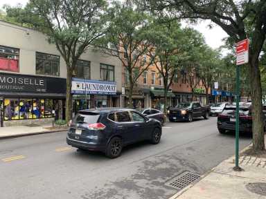 storefronts along a street in Glendale and Ridgewood where the IBX will stop