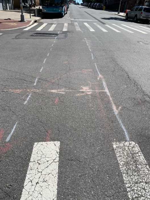 Major Queens street undergoes redesign to become one-way for drivers; new bike lanes to be added 2 street pavement with white markings in Queens