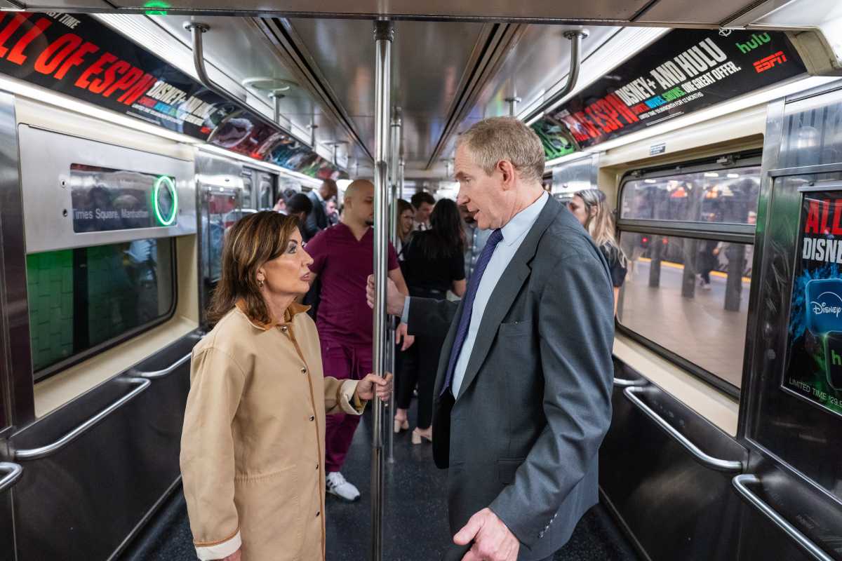 woman and man on subway train car speaking about subway crime