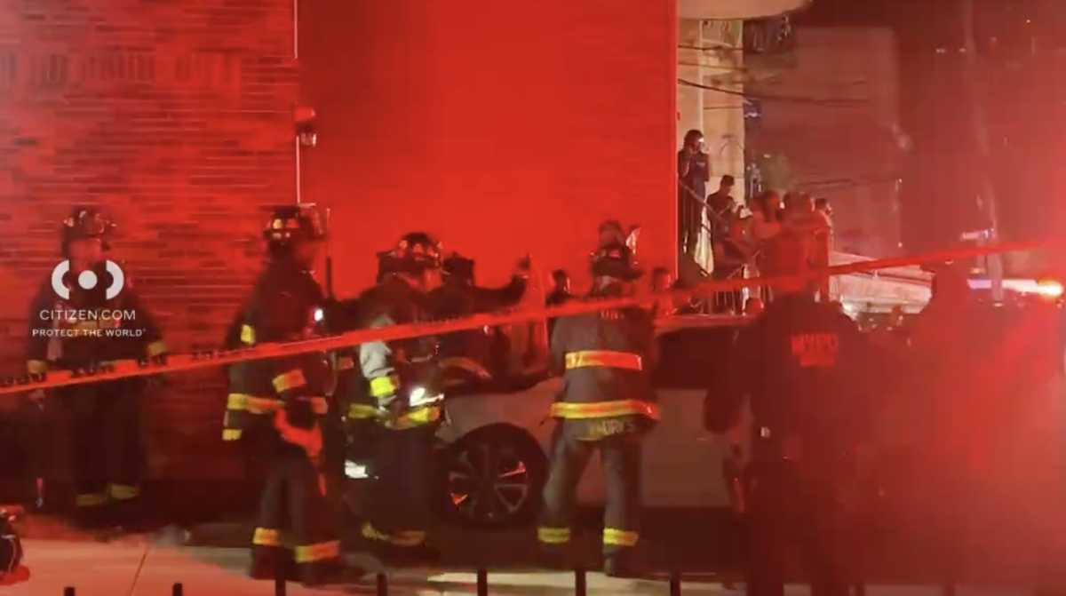 Police and firefighters at scene of Queens crash