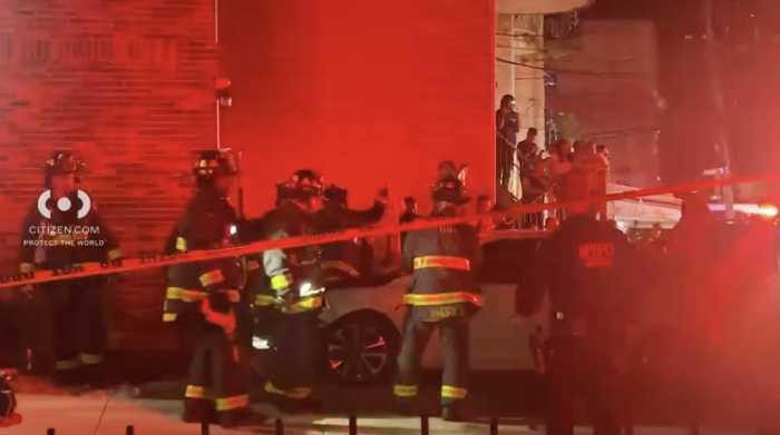 Police and firefighters at scene of Queens crash