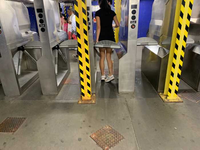 turnstiles at a subway entrance in Queens