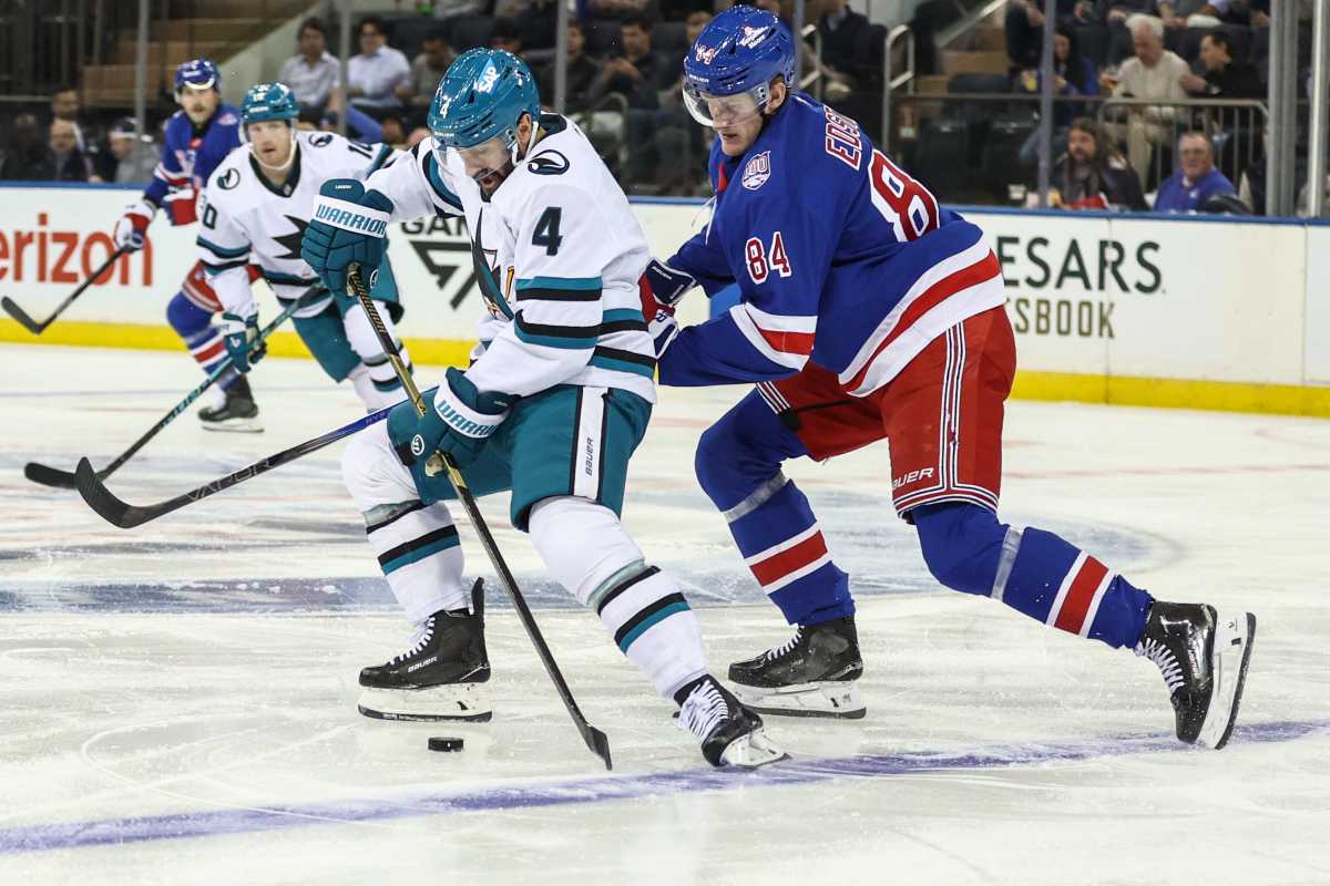 San Jose Sharks defenseman Nick Leddy (4) and New York Rangers center Adam Edstrom (84) battle for control of the puck in the first period at Madison Square Garden.