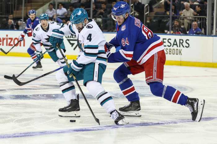 San Jose Sharks defenseman Nick Leddy (4) and New York Rangers center Adam Edstrom (84) battle for control of the puck in the first period at Madison Square Garden.