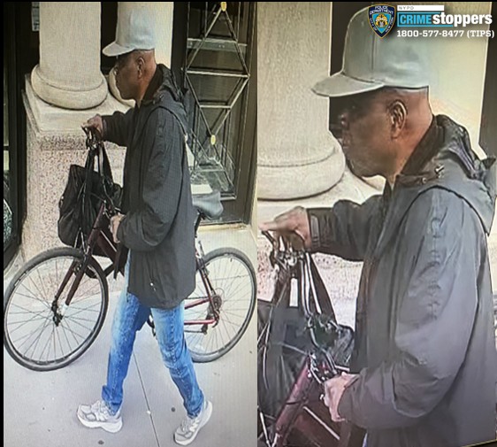 man in white hat walking with a bike and holding bags