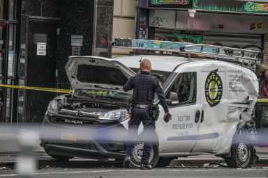 Van damaged in chain reaction crash in Midtown Manhattan that left 10 people injured.