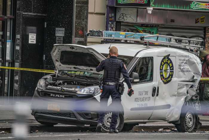 Van damaged in chain reaction crash in Midtown Manhattan that left 10 people injured.