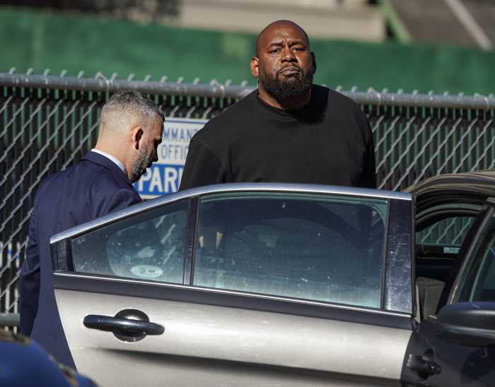 BLM New York founder Hawk Newsome surrnders on Harlem felony assault charges, calls arrest 'political attack' 1 BLM New York Co-founder Hawk Newsome looks at cameras following his arrest.