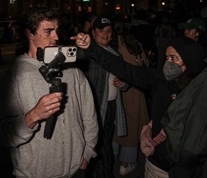 A protester gestures toward Nick Shirly during a rally outside 26 Federal Plaza on Wednesday 