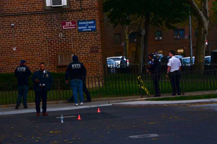 Man shot in the head and critically injured in Brooklyn, police say 2 Detectives work inside the cordoned-off parking lot of a NYCHA complex