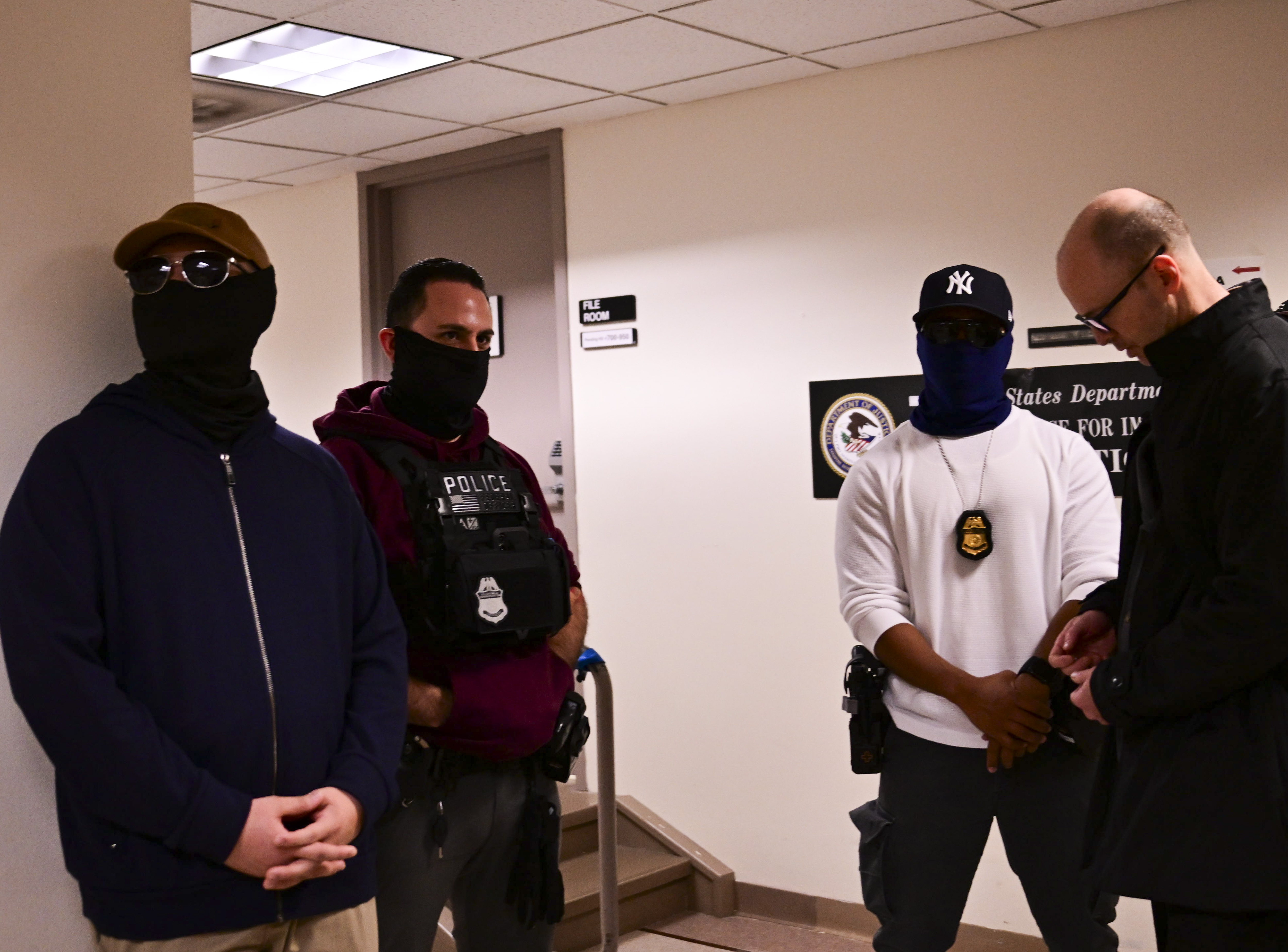 Priest Joe Hoover prays with the ICE Agents.