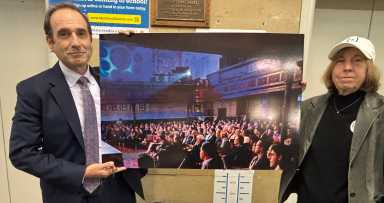 Attorney Michael Hiller and West Park Center's Debby Hirshman show a picture of a full house in the church.