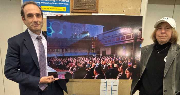 Attorney Michael Hiller and West Park Center's Debby Hirshman show a picture of a full house in the church.