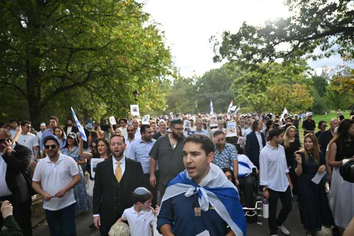 Participants march and sing around the Great Lawn in Central Park during the “Circle of Unity” vigil on Tuesday, Oct. 7, 2025, marking the second anniversary of the Oct. 7, 2023, terrorist attacks in Israel.
