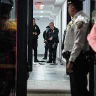 Cop wounded in shooting at Bronx apartment building while attempting to stop robbery suspect 18 NYPD at scene in Bronx hallway where cop was shot