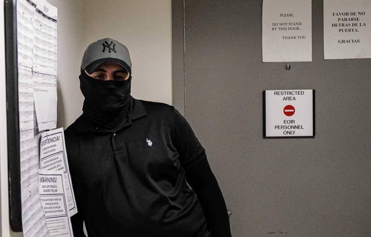 An ICE agent waits outside of a courtroom at 26 Federal Plaza in Manhattan on Oct. 1, 2025.