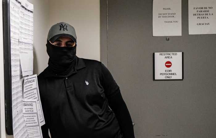 An ICE agent waits outside of a courtroom at 26 Federal Plaza in Manhattan on Oct. 1, 2025.