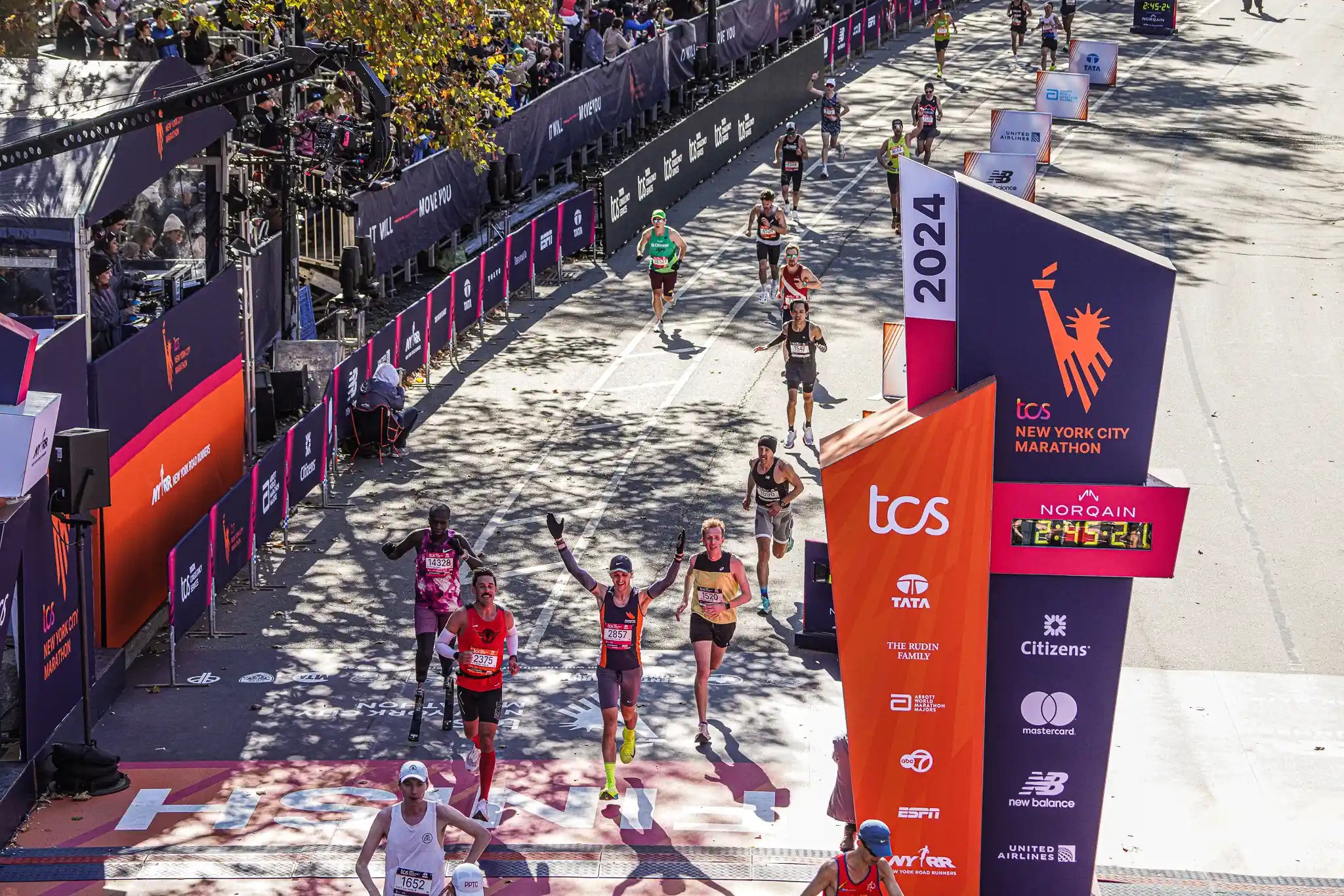 NYC MARATHON | Running through time: How New York Road Runners became what it is today 2 Runners cross the finish line at the TCS NYC Marathon