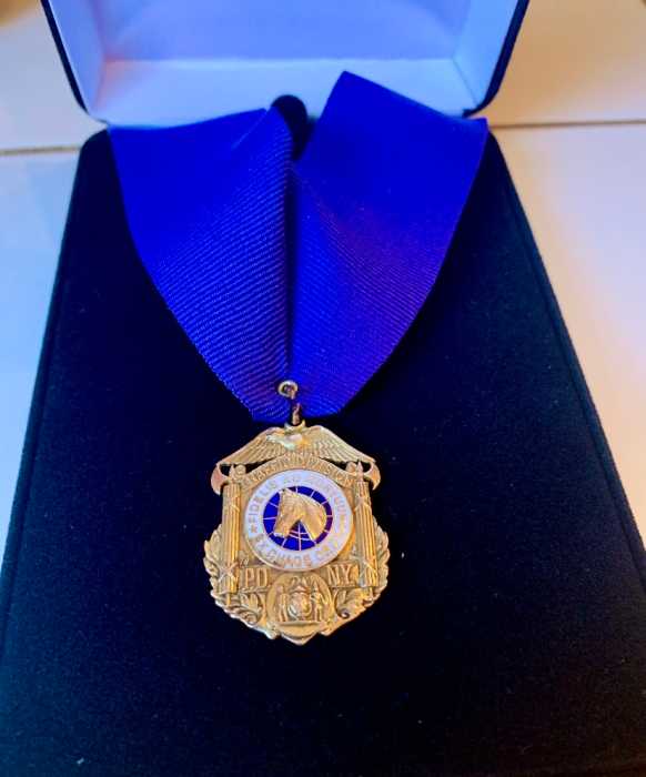 Band of blue: Retired NYPD officers with thousands of artifacts advocate for opening new police museum in NYC 7 a gold medal on a blue ribbon