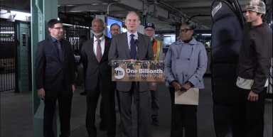 people standing around a podium in a Brooklyn subway station