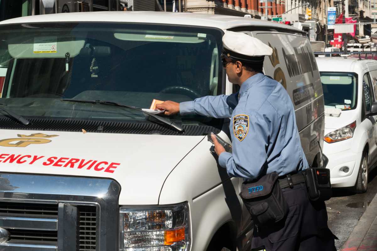 traffic agent issuing parking violation ticket that includes high fines