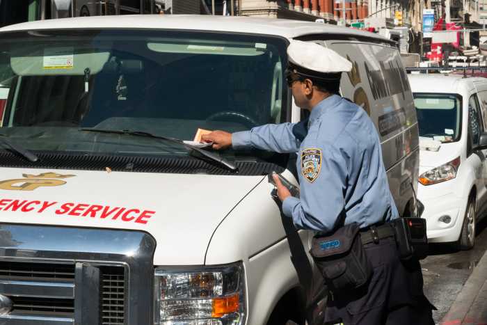 traffic agent issuing parking violation ticket that includes high fines