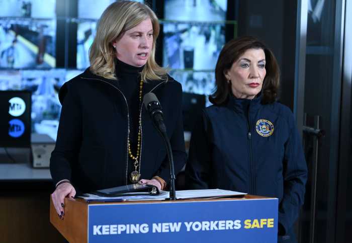 two women dressed in black at a podium