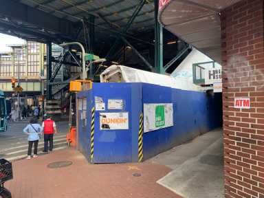 an intersection with construction in near a 7 train stop