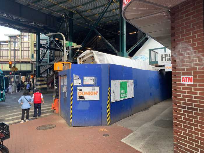 an intersection with construction in near a 7 train stop