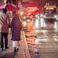 Daylight saving time ends this Sunday. Here's why NYC is stepping up its traffic enforcement as the clocks fall back. 6 people walking on rainy winter street in NYC after daylight savings time ended