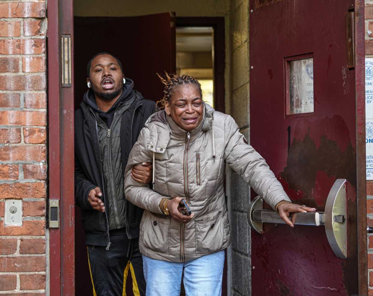 A woman weeps at scene of Bronx murder-suicide