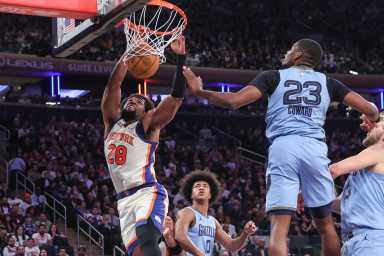 Nov 11, 2025; New York, New York, USA; New York Knicks forward Guerschon Yabusele (28) dunks past Memphis Grizzlies forward Cedric Coward (23) in the second quarter at Madison Square Garden.