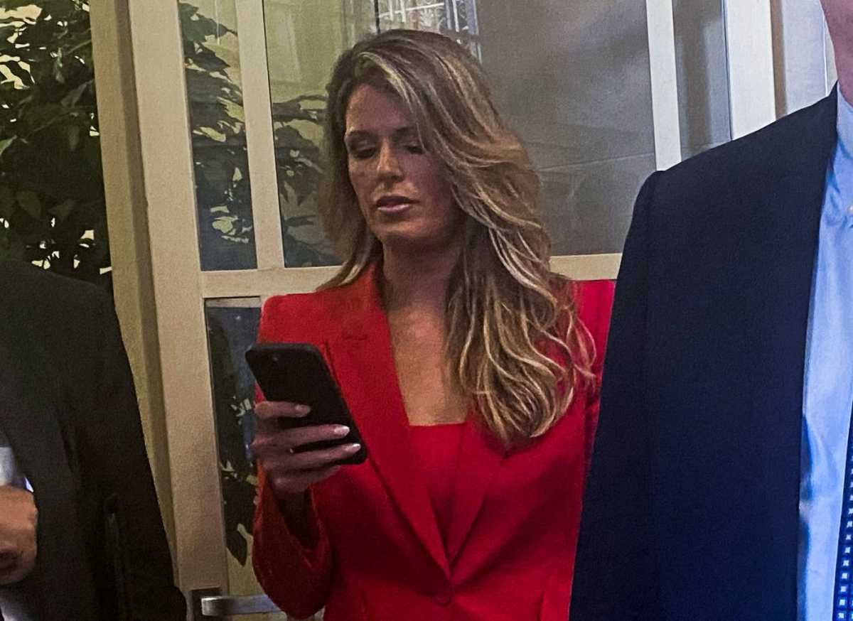 LIndsey Halligan, prosecutor who indicted Letitia James, looking at her cell phone